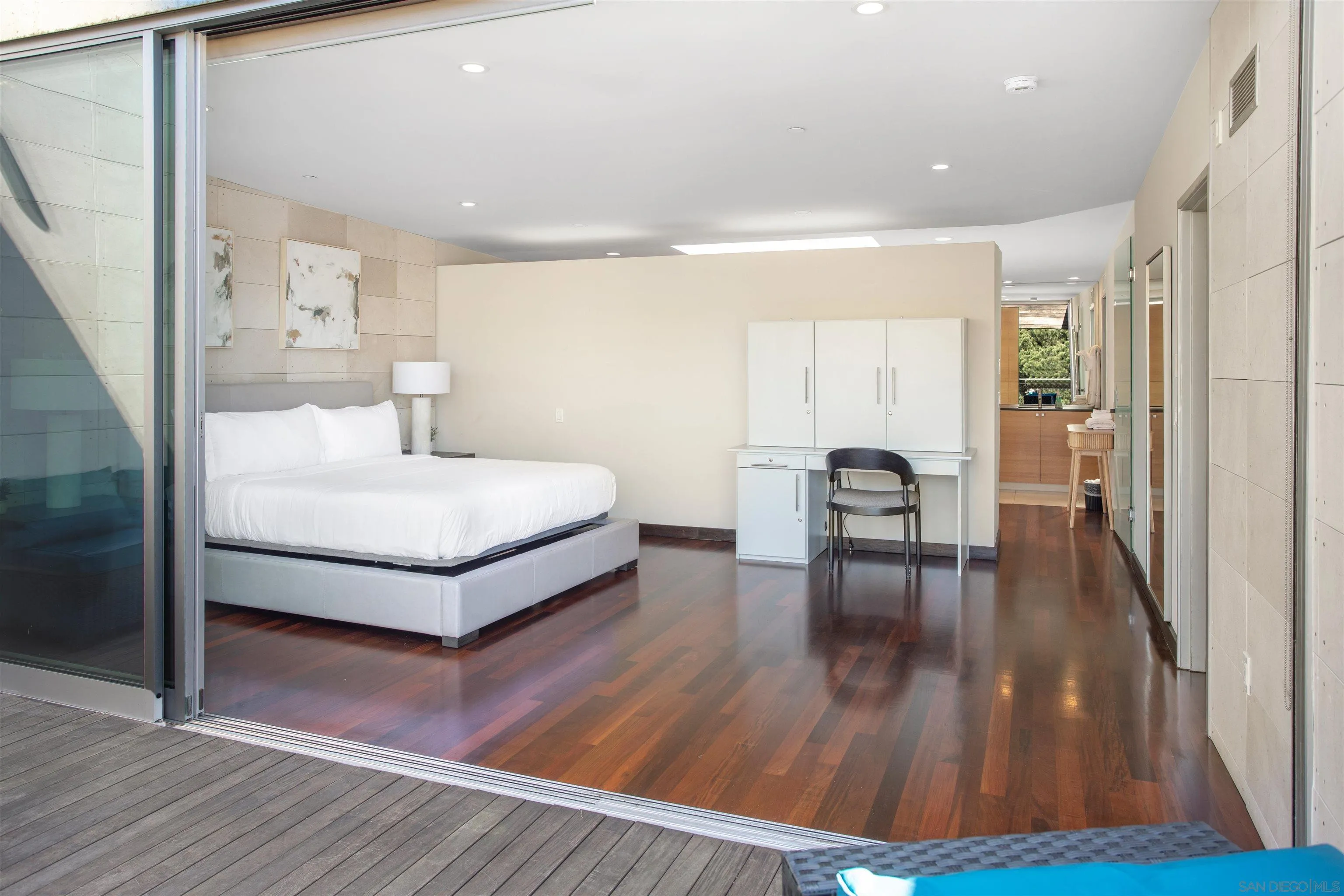 427 Ravina Street La Jolla, CA 92037 - Photo 19 of 36 a spacious bedroom with a bed and wooden floor