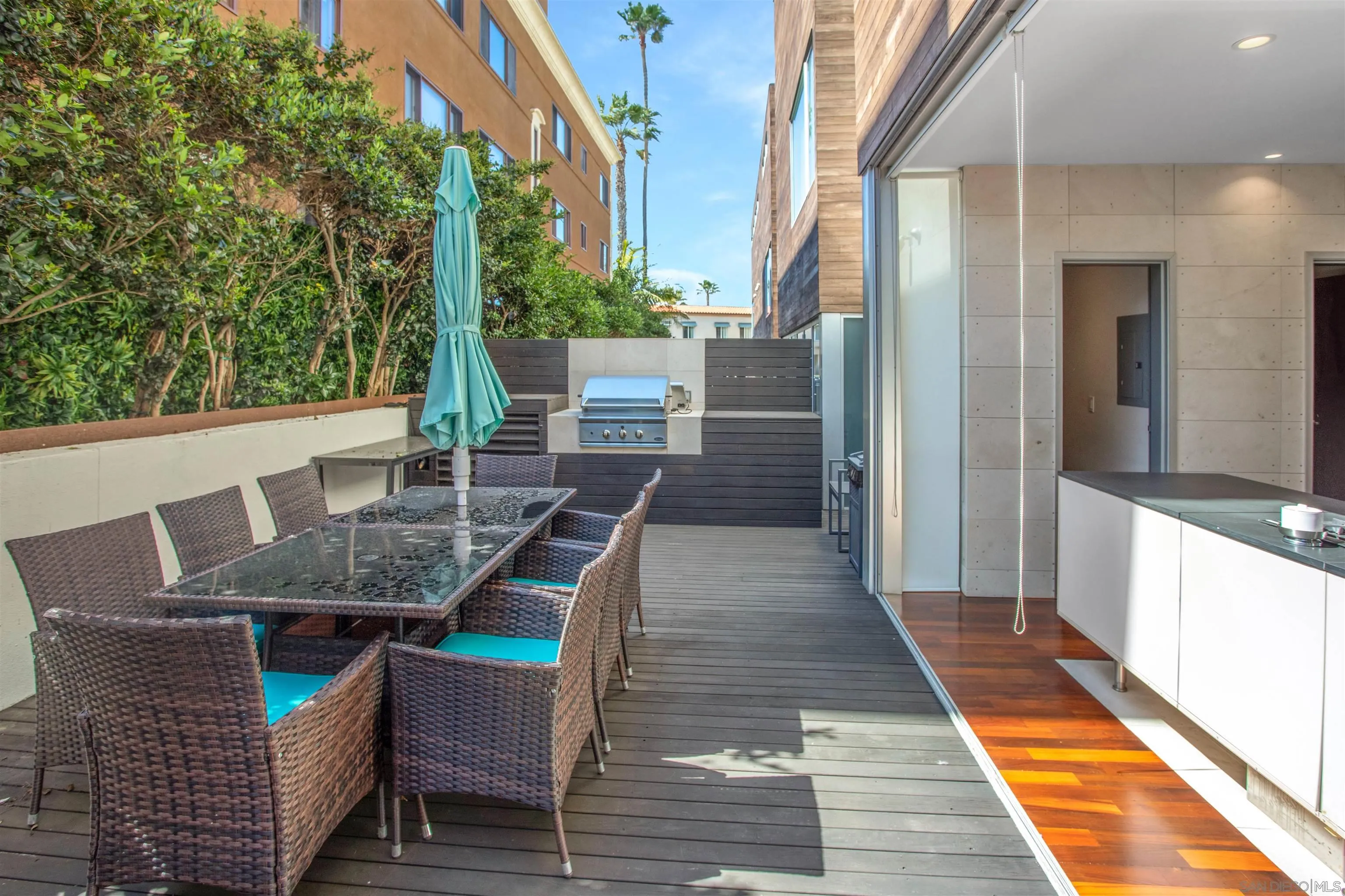 427 Ravina Street La Jolla, CA 92037 - Photo 6 of 36 a view of a patio with table and chairs with wooden floor and fence