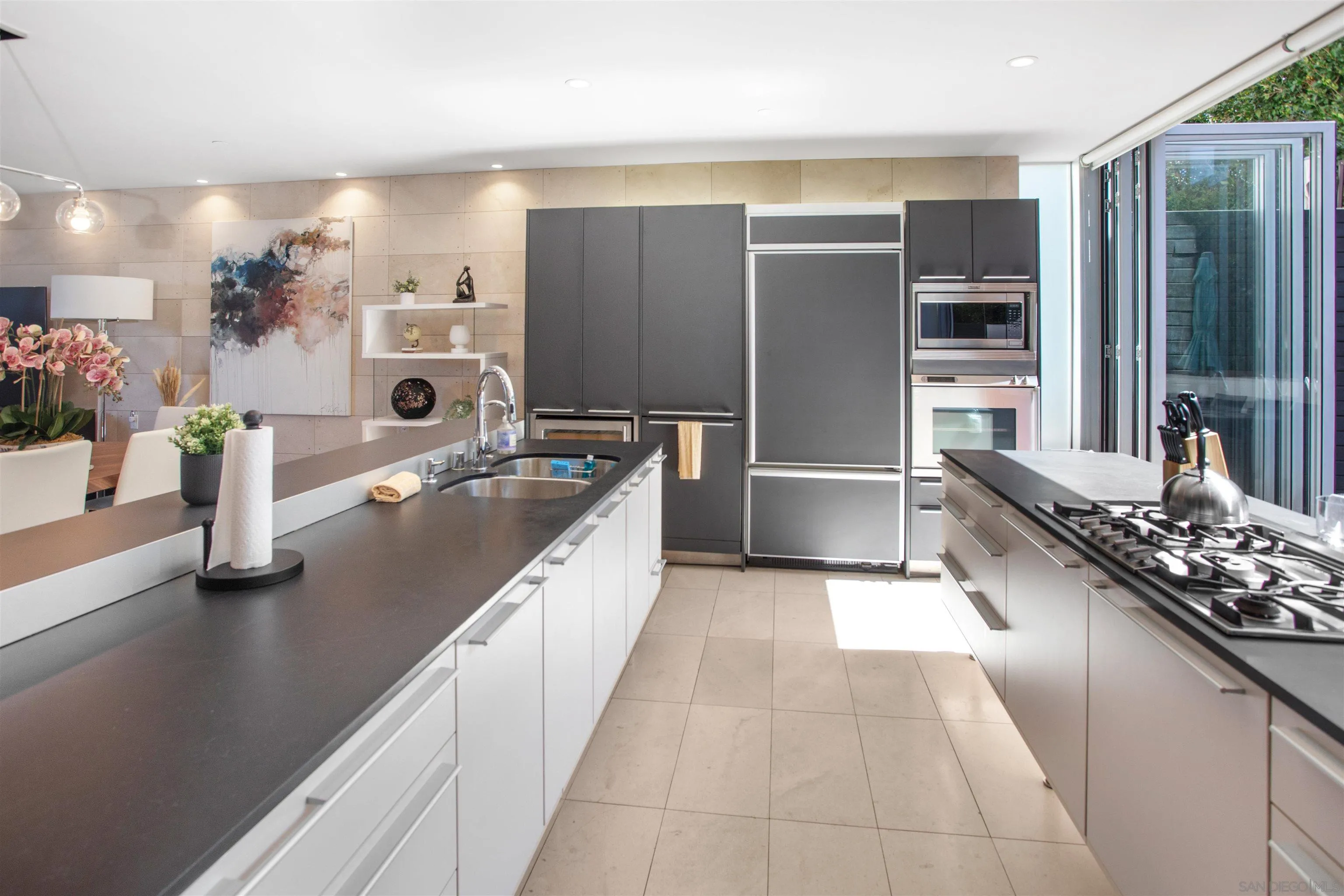 427 Ravina Street La Jolla, CA 92037 - Photo 8 of 36 a kitchen with stainless steel appliances granite countertop a sink stove and refrigerator