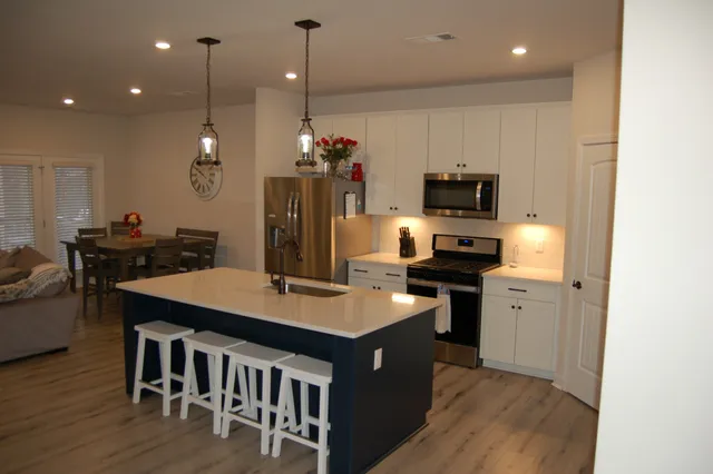a kitchen with a table chairs stove and microwave