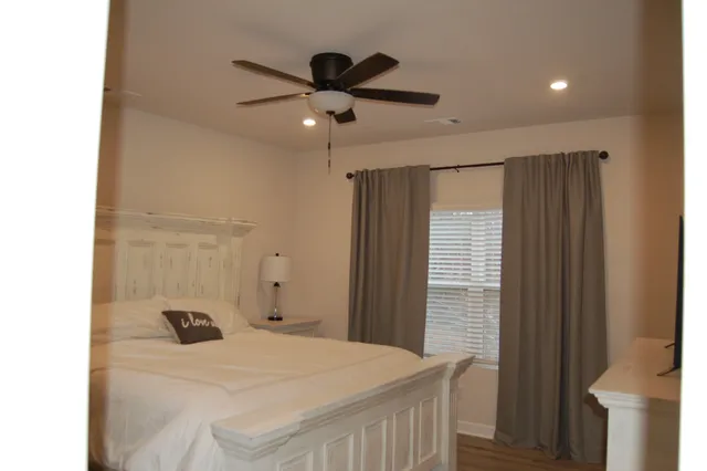 a bathroom with a granite countertop sink a mirror and a shower