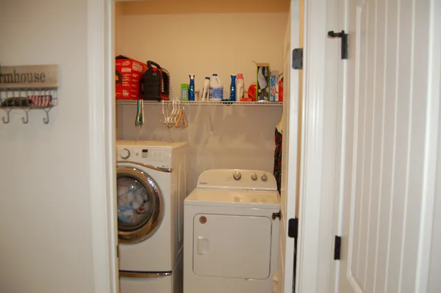 a kitchen with kitchen island a dining table and chairs