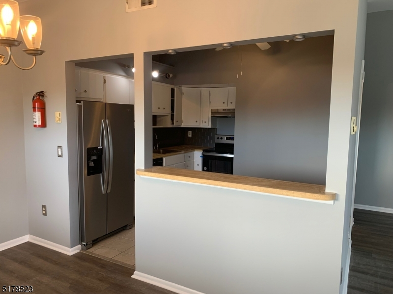 2 Evergreen Drive Clinton, NJ 08809 - Photo 7 of 18 a metallic refrigerator freezer sitting in a kitchen