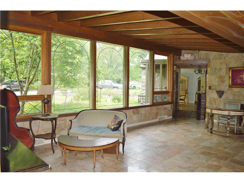 Living Room. A view through the large - open living room toward the wall of windows that overlook the front yard.  The large windows are double pane, insulated, Pella windows,
