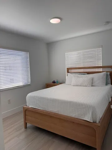 a bedroom with a bed and window