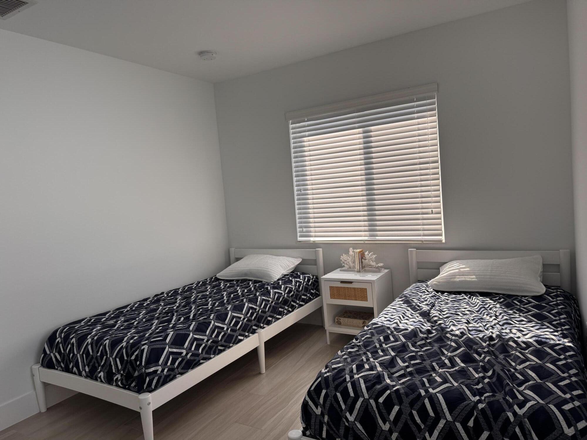 94825 Overseas Highway, Unit 58 Key Largo, FL 33037 - Photo 18 of 41 a bedroom with two beds and a window