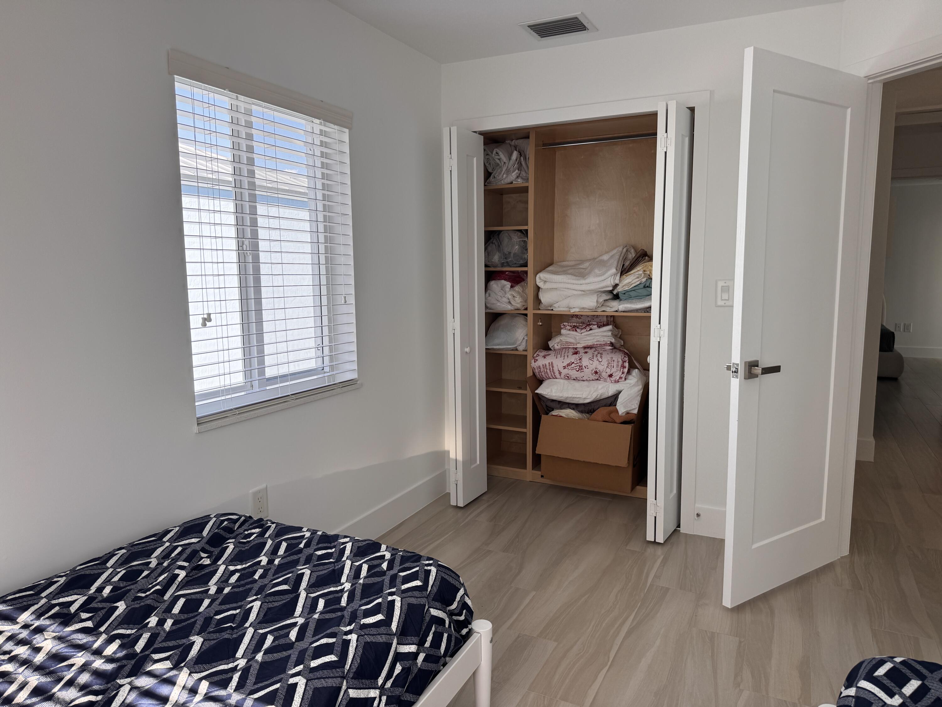 94825 Overseas Highway, Unit 58 Key Largo, FL 33037 - Photo 19 of 41 a bedroom with a bed and wooden floor