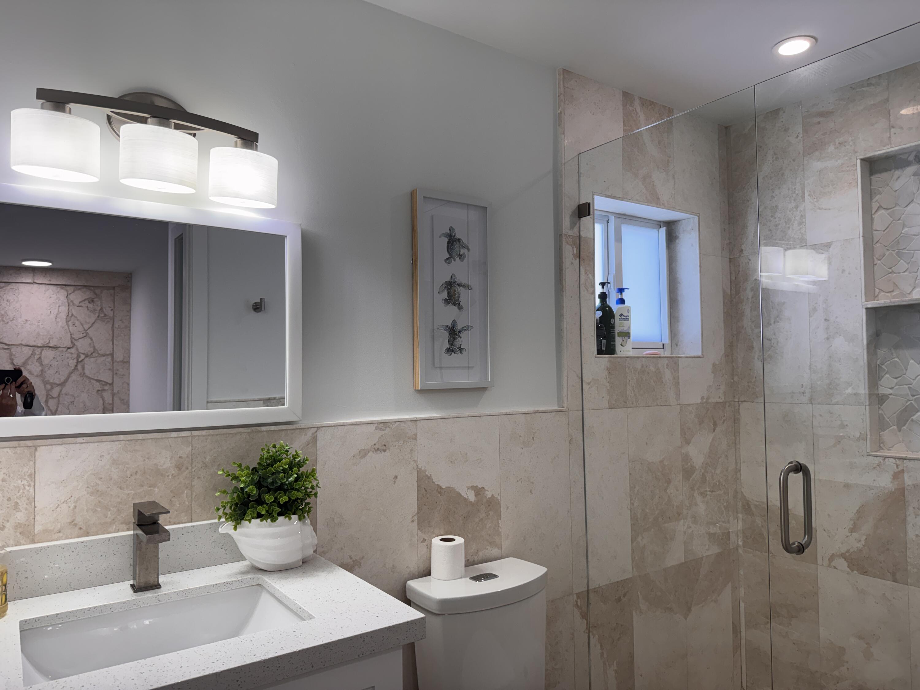 94825 Overseas Highway, Unit 58 Key Largo, FL 33037 - Photo 23 of 41 a bathroom with a sink and mirror