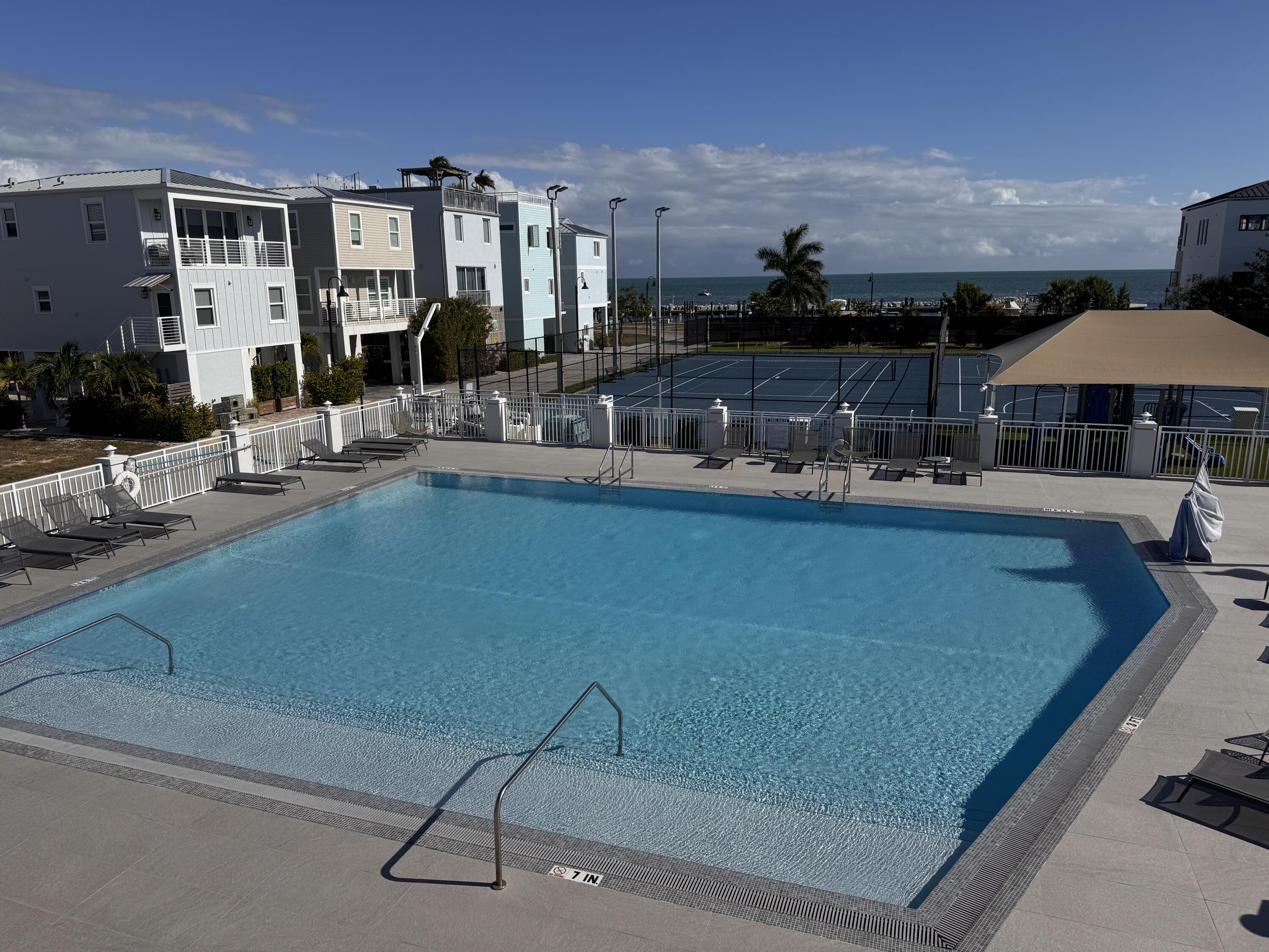 94825 Overseas Highway, Unit 58 Key Largo, FL 33037 - Photo 3 of 41 a dining room with table and chairs