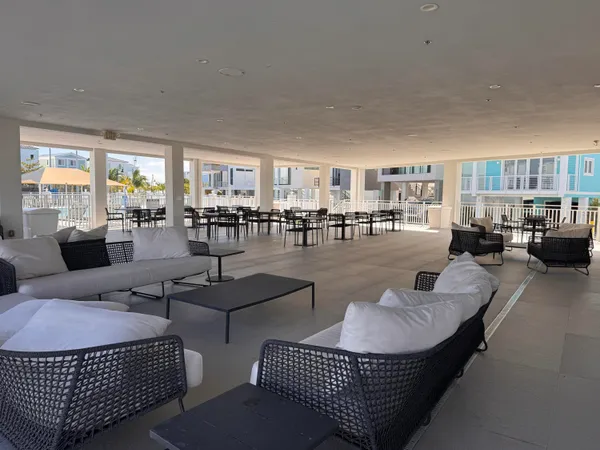 a living room with furniture and view of kitchen