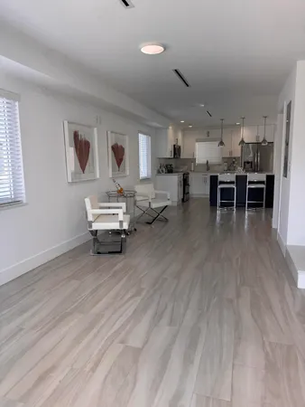 a living room with furniture and kitchen view