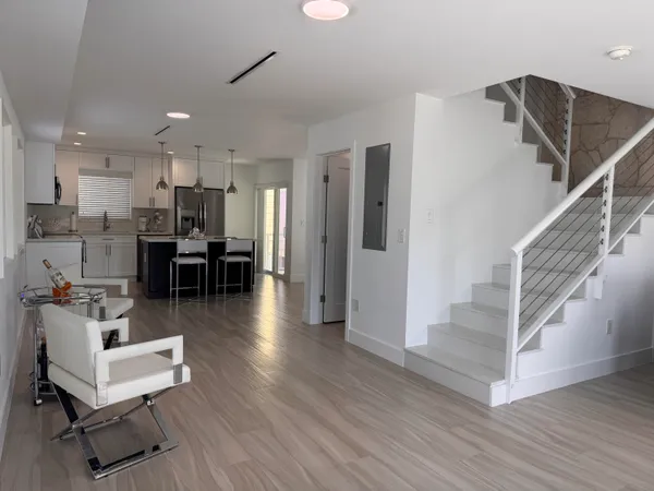 a view of kitchen with furniture and wooden floor