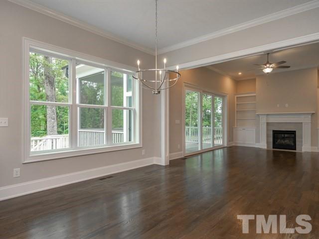 1425 Starry Night Court Raleigh, NC 27613 - Photo 12 of 33 a view of an empty room with wooden floor fireplace and a window