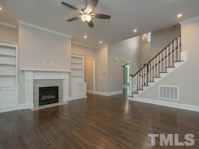 1425 Starry Night Court Raleigh, NC 27613 - Photo 15 of 33 a view of an empty room with wooden floor fireplace and a window
