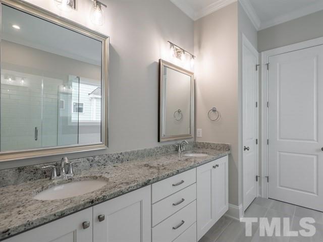 1425 Starry Night Court Raleigh, NC 27613 - Photo 19 of 33 a bathroom with a granite countertop double vanity sink and mirror