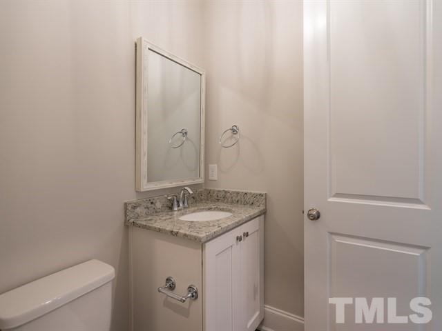 1425 Starry Night Court Raleigh, NC 27613 - Photo 4 of 33 a bathroom with a granite countertop sink and a mirror