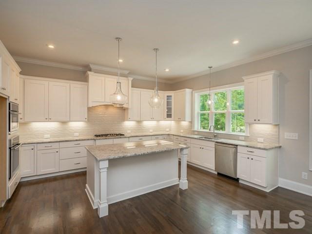 1425 Starry Night Court Raleigh, NC 27613 - Photo 8 of 33 a kitchen with granite countertop white cabinets and white appliances