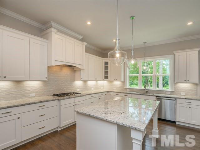 1425 Starry Night Court Raleigh, NC 27613 - Photo 10 of 33 a kitchen with granite countertop a sink window and cabinets