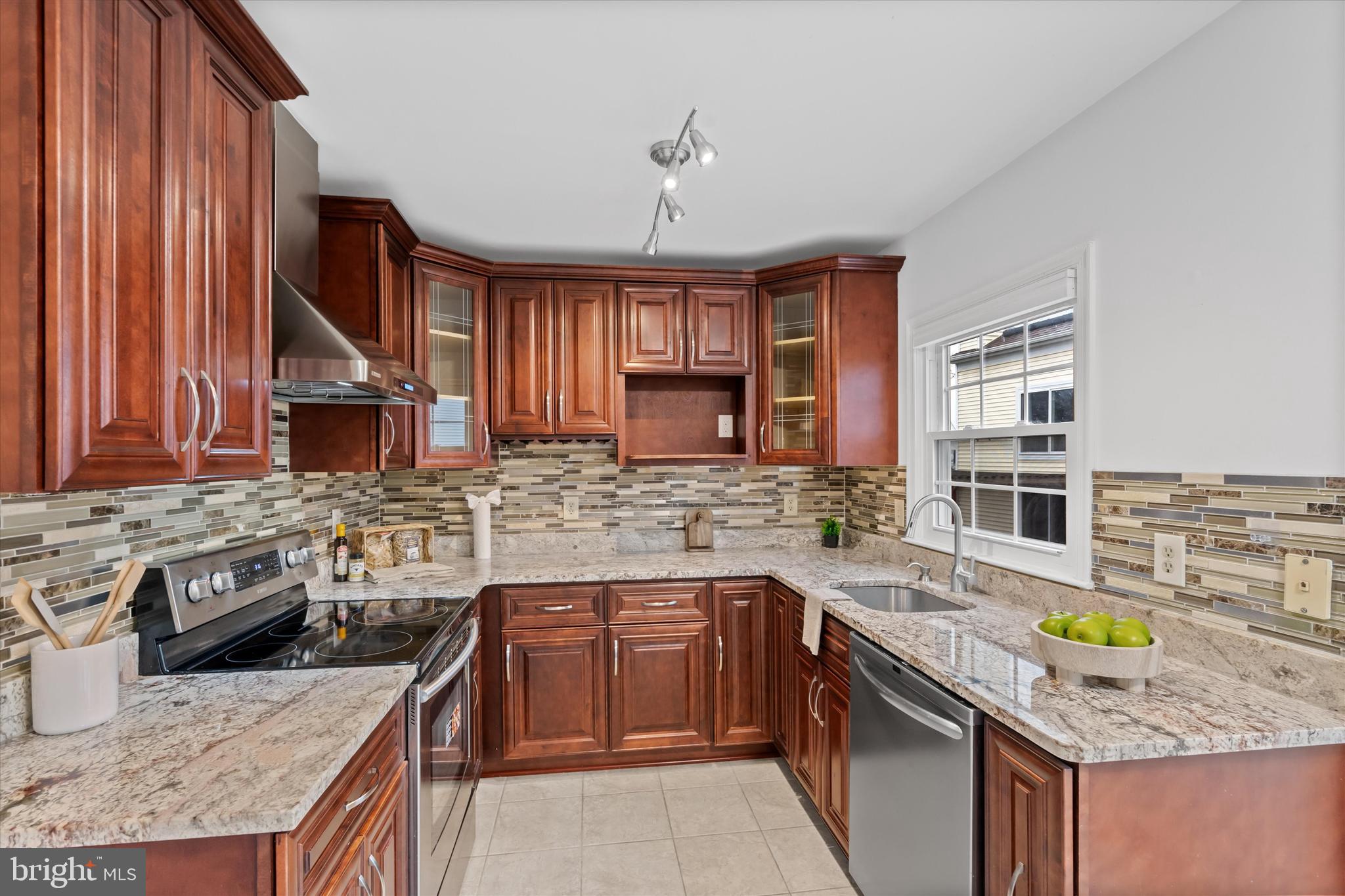 14810 Cherry Leaf Terrace Silver Spring, MD 20906 - Photo 11 of 35 a kitchen with stainless steel appliances granite countertop a sink stove and cabinets