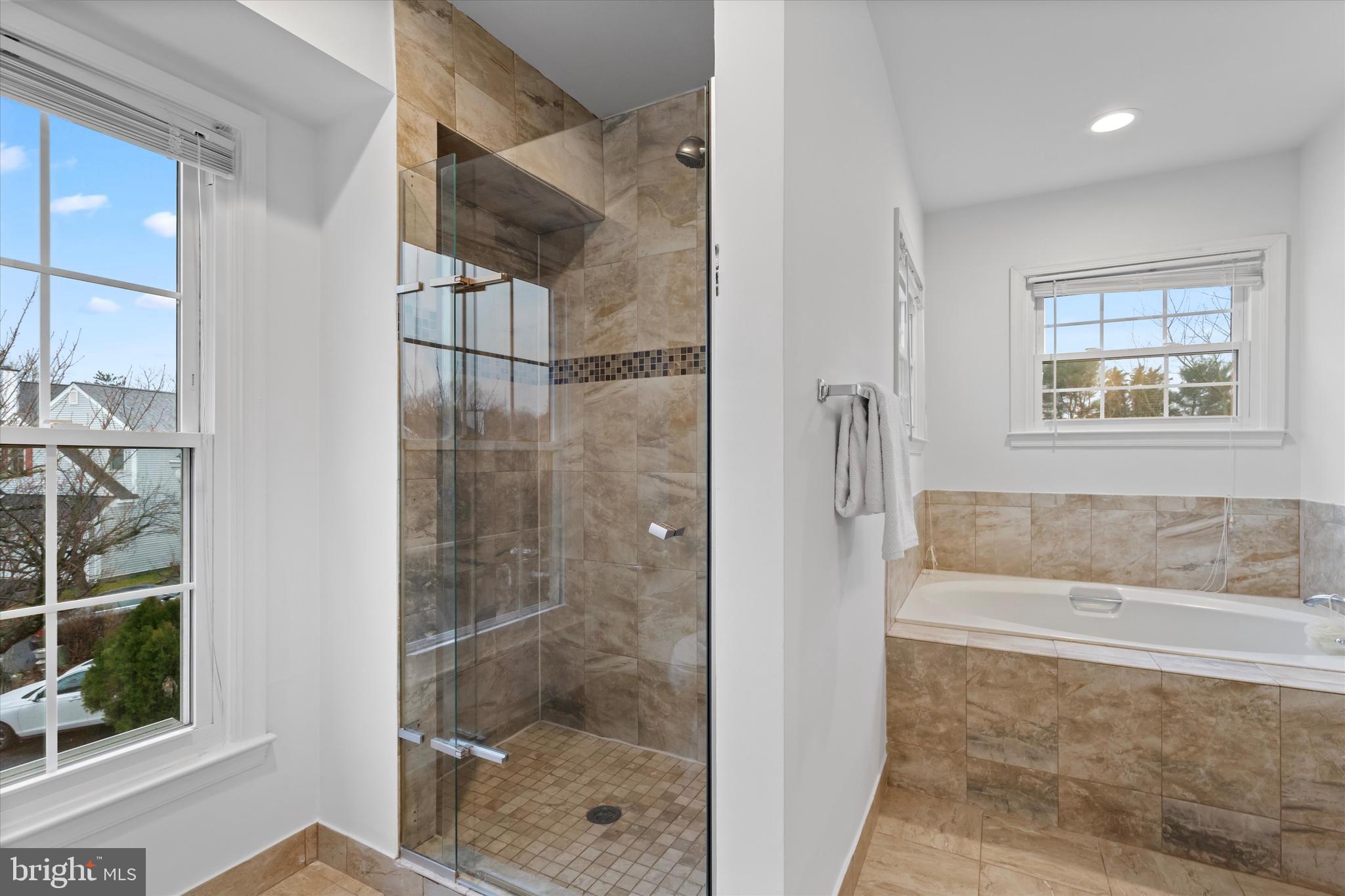 14810 Cherry Leaf Terrace Silver Spring, MD 20906 - Photo 15 of 35 a bathroom with a bathtub and a shower