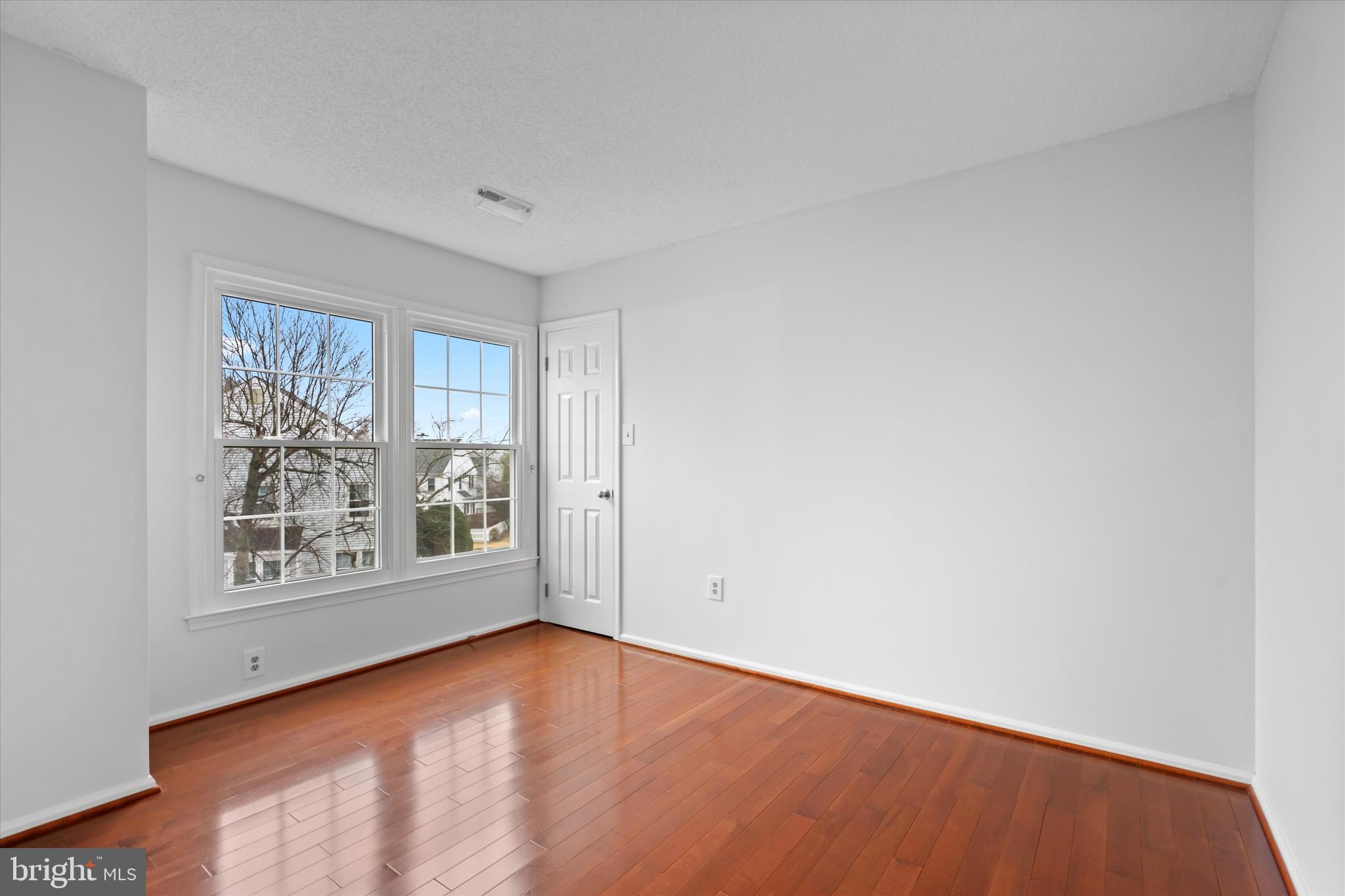 14810 Cherry Leaf Terrace Silver Spring, MD 20906 - Photo 18 of 35 wooden floor in an empty room with a window
