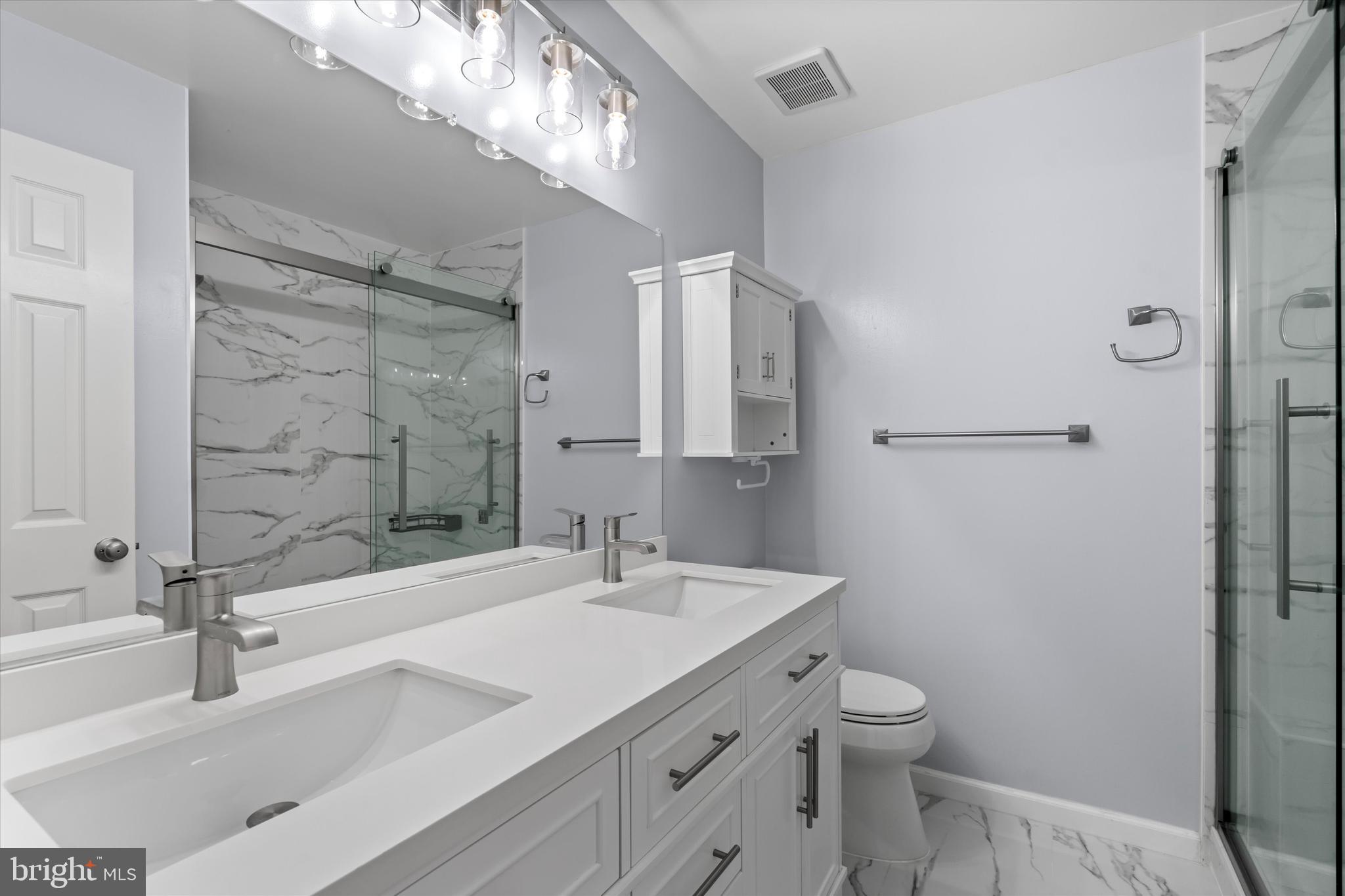 14810 Cherry Leaf Terrace Silver Spring, MD 20906 - Photo 19 of 35 a bathroom with a sink a toilet and shower