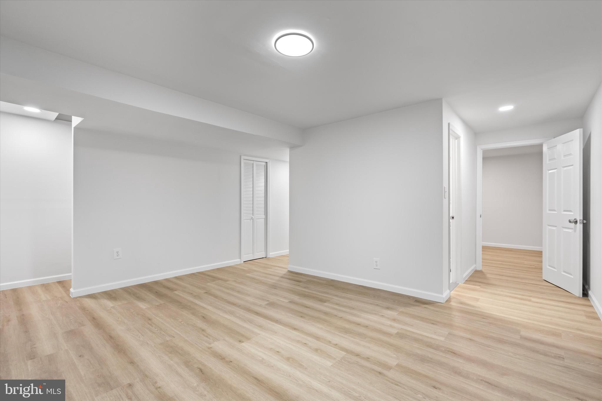 14810 Cherry Leaf Terrace Silver Spring, MD 20906 - Photo 23 of 35 a view of an empty room with wooden floor and a window