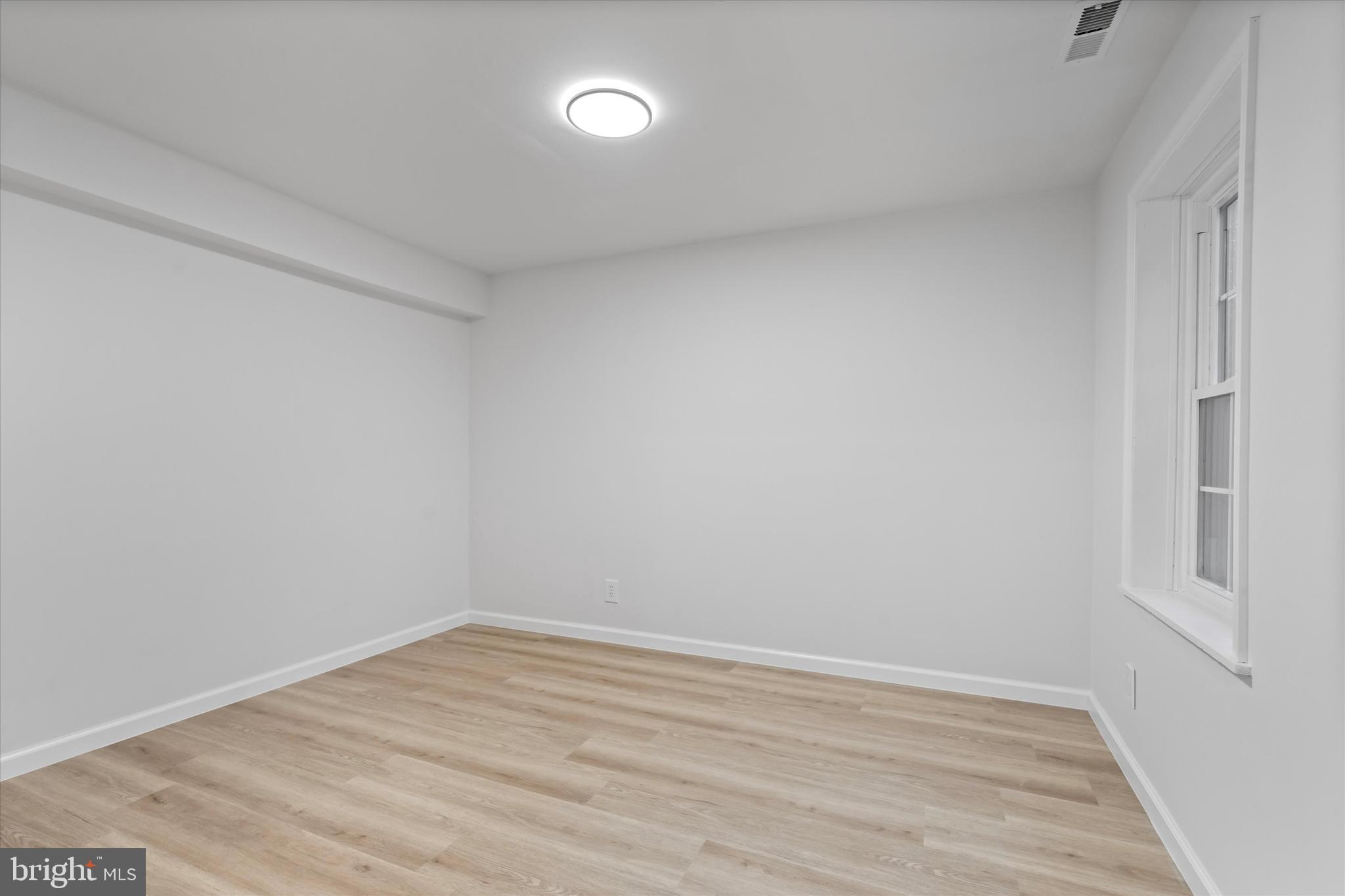 14810 Cherry Leaf Terrace Silver Spring, MD 20906 - Photo 24 of 35 a view of an empty room with wooden floor and a window