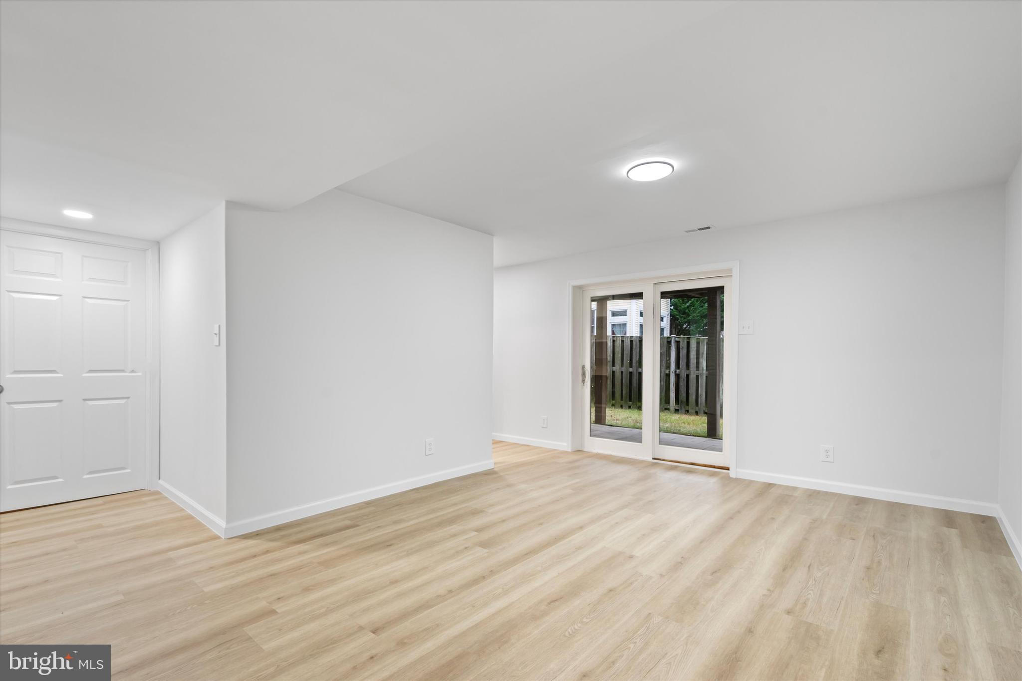 14810 Cherry Leaf Terrace Silver Spring, MD 20906 - Photo 26 of 35 a view of an empty room with wooden floor and a window