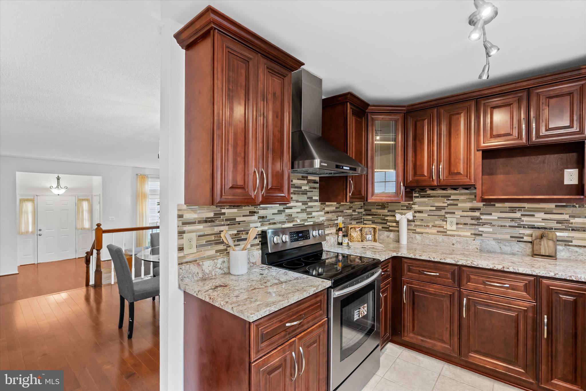 14810 Cherry Leaf Terrace Silver Spring, MD 20906 - Photo 10 of 35 a kitchen with a stove cabinets and wooden floor