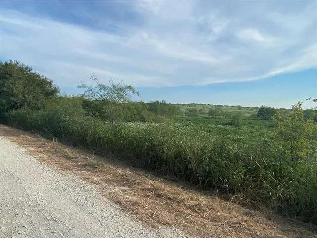 a view of a road with a yard