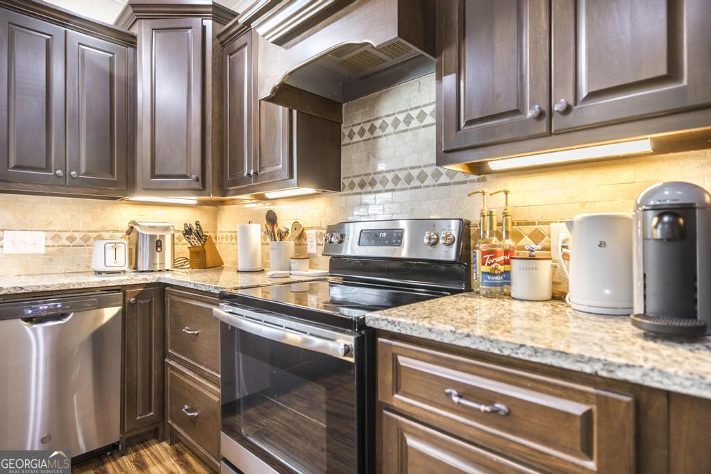 219 Rowland Circle Byron, GA 31008 - Photo 15 of 47 a kitchen with granite countertop cabinets stainless steel appliances and sink