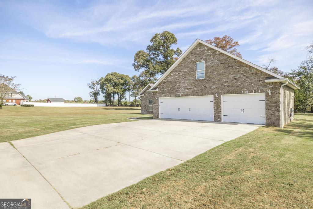 219 Rowland Circle Byron, GA 31008 - Photo 2 of 47 a front view of a house with a yard and garage