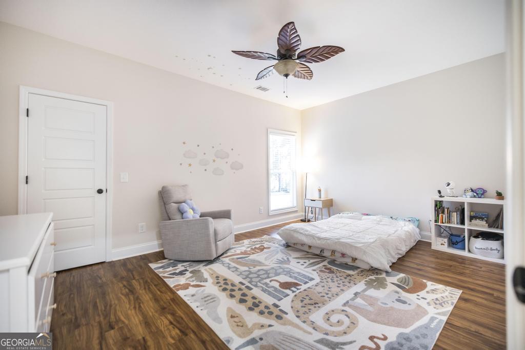 219 Rowland Circle Byron, GA 31008 - Photo 24 of 47 a bedroom with a bed and a chandelier