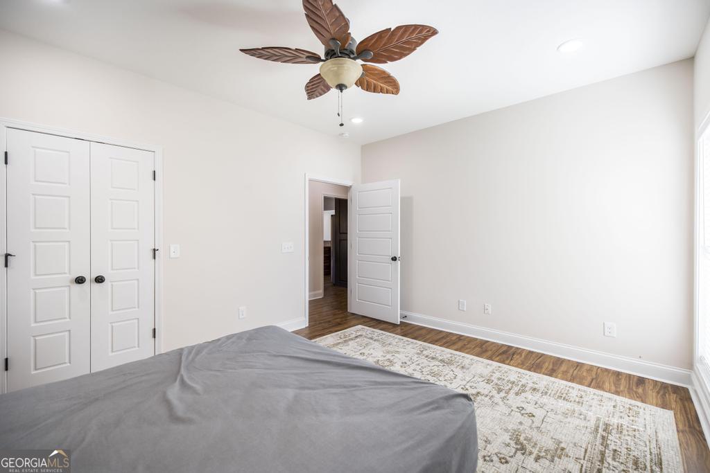 219 Rowland Circle Byron, GA 31008 - Photo 28 of 47 a bedroom with a bed and a chandelier fan