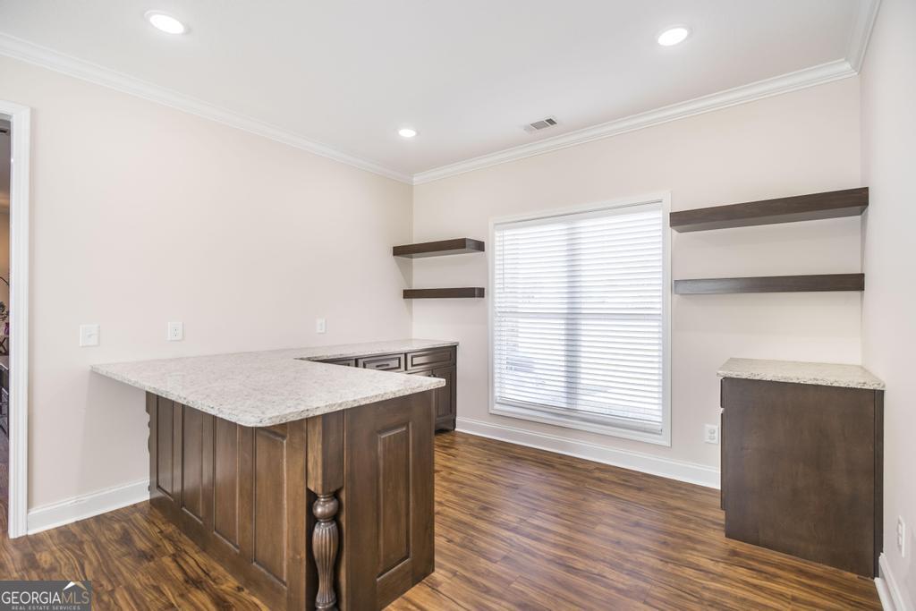 219 Rowland Circle Byron, GA 31008 - Photo 30 of 47 a kitchen with a stove a refrigerator and wooden floor