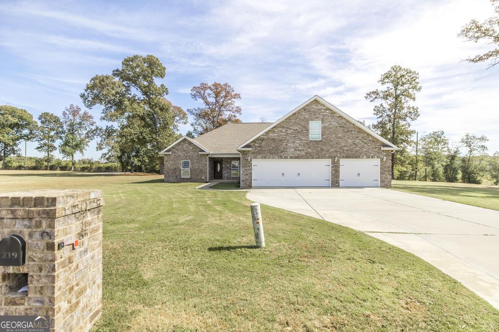 219 Rowland Circle Byron, GA 31008 - Photo 3 of 47 a front view of a house with a yard and garage