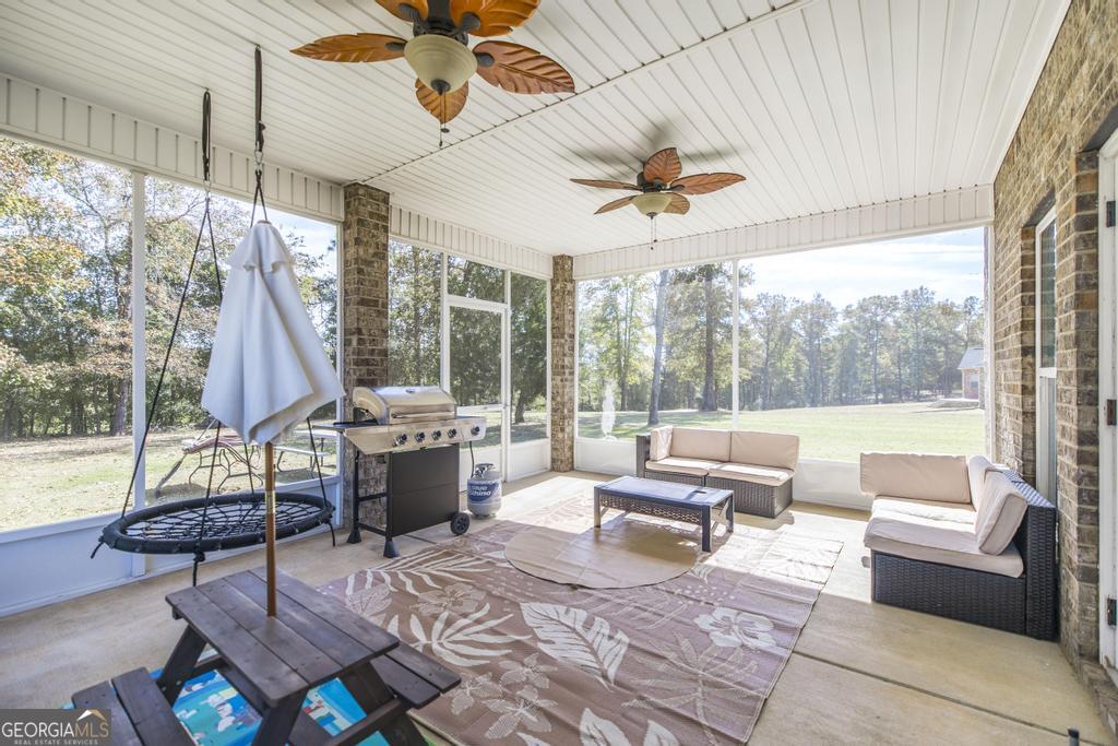 219 Rowland Circle Byron, GA 31008 - Photo 31 of 47 a living room with patio furniture and a floor to ceiling window