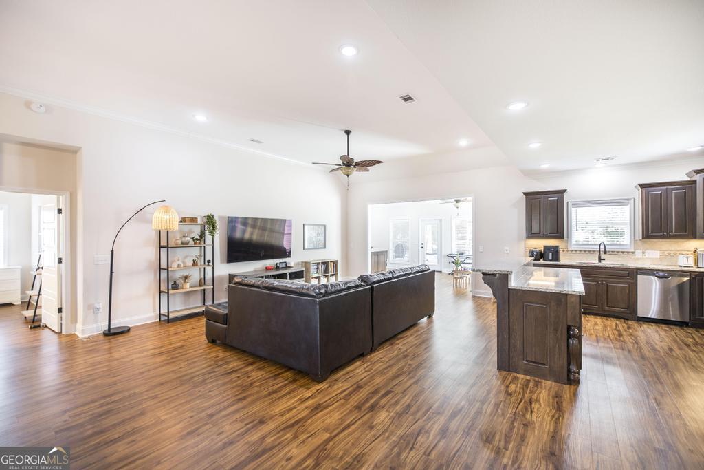 219 Rowland Circle Byron, GA 31008 - Photo 10 of 47 a living room with couches kitchen view and a wooden floor