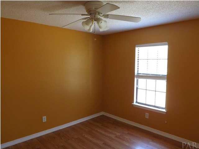 5538 Allie Rae Street Milton, FL 32570 - Photo 12 of 24 Additional Bedroom, number 3, also has nice flooring and a fan