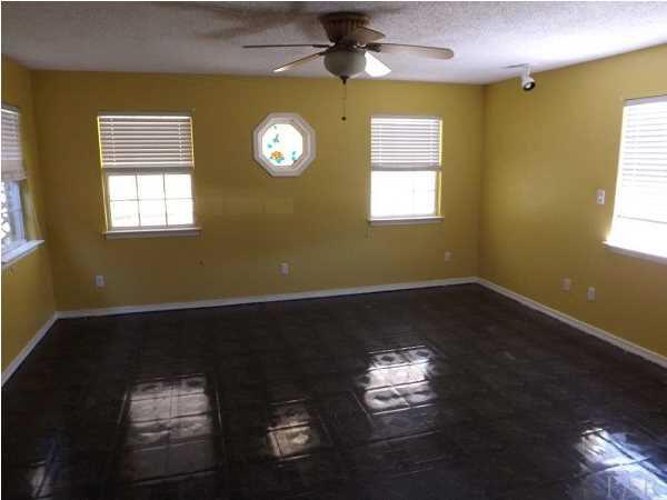 5538 Allie Rae Street Milton, FL 32570 - Photo 13 of 24 The Master Bedroom has an interesting stain glass window as a focal point
