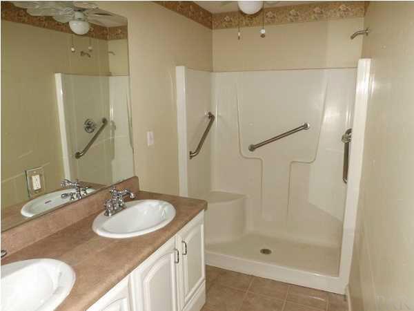 5538 Allie Rae Street Milton, FL 32570 - Photo 14 of 24 The Master Bathroom features a stand up shower with built in seat and a double vanity
