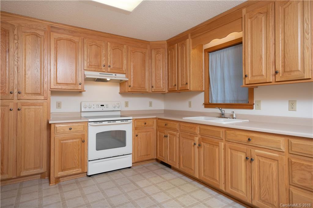 2746 Sawmill Road Hickory Grove, SC 29717 - Photo 12 of 27 a kitchen with granite countertop white cabinets and stainless steel appliances