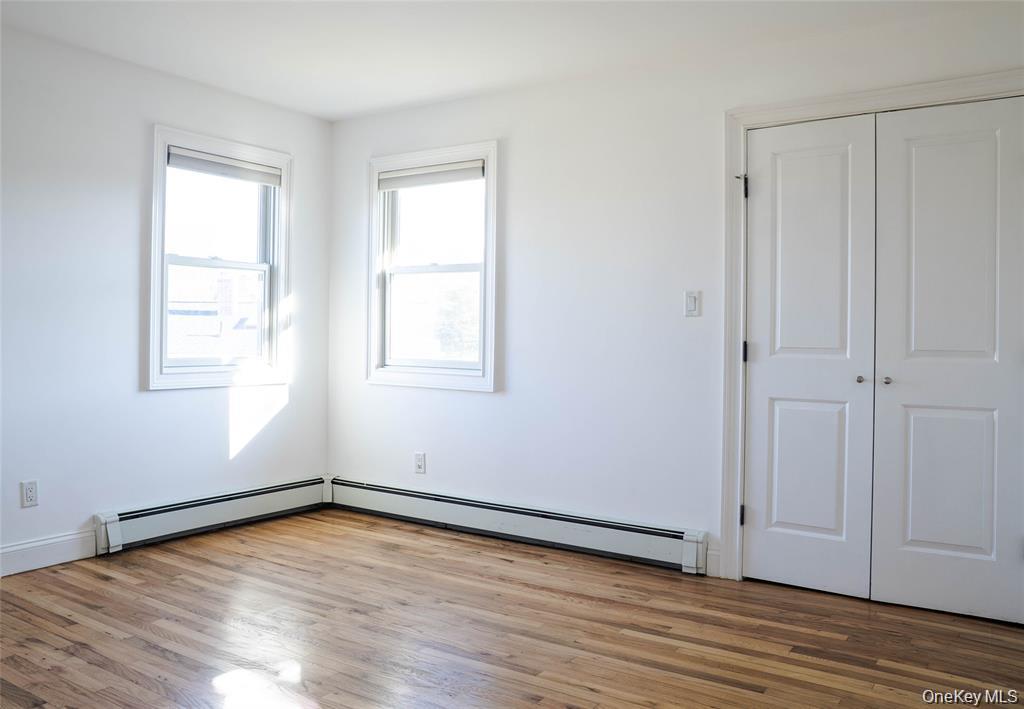 58 Hauppauge Road Hauppauge, NY 11788 - Photo 13 of 23 an empty room with wooden floor and windows