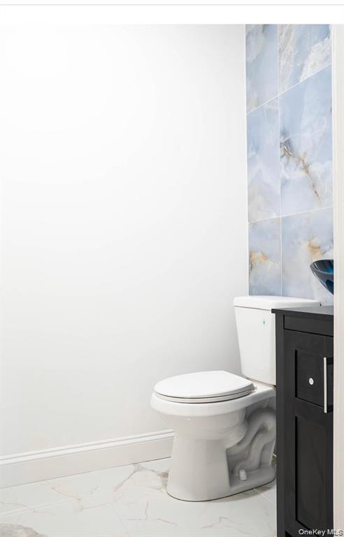 58 Hauppauge Road Hauppauge, NY 11788 - Photo 14 of 23 a white toilet sitting next to a bathroom sink