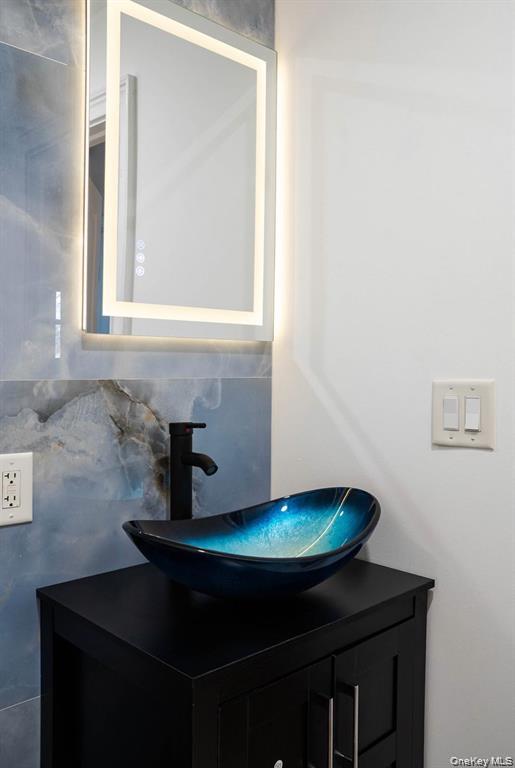 58 Hauppauge Road Hauppauge, NY 11788 - Photo 15 of 23 a bathroom with a sink and a mirror