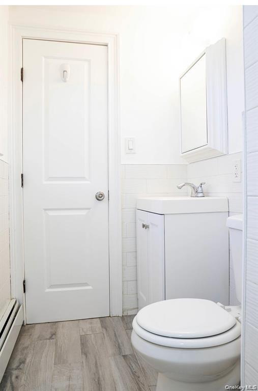 58 Hauppauge Road Hauppauge, NY 11788 - Photo 19 of 23 a white toilet sitting next to a bathroom sink