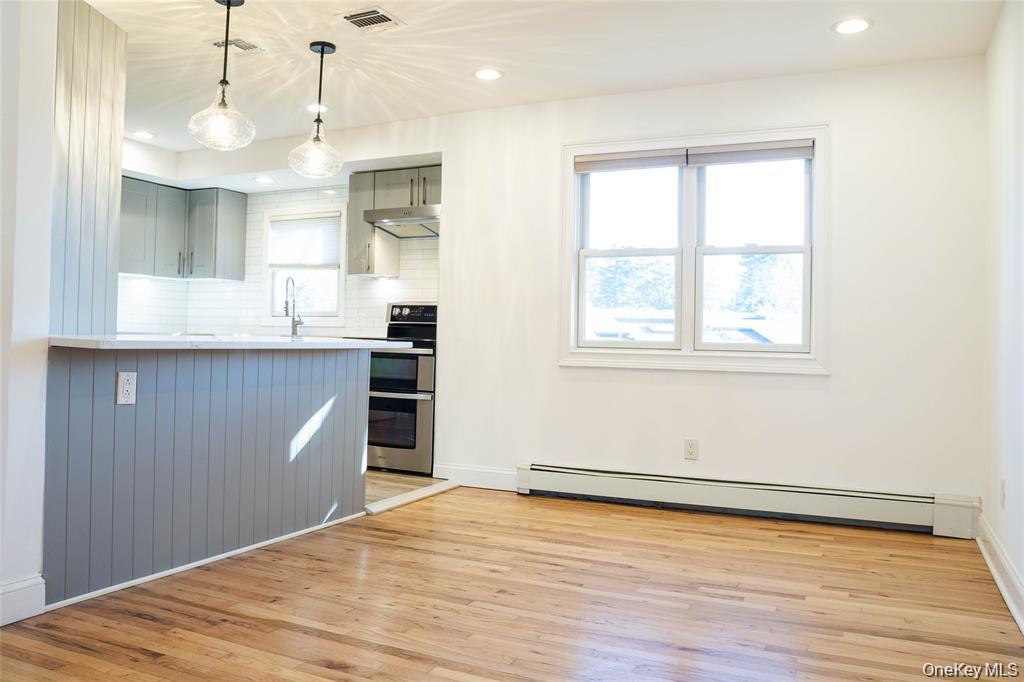 58 Hauppauge Road Hauppauge, NY 11788 - Photo 5 of 23 a view of a kitchen with wooden floor and a window