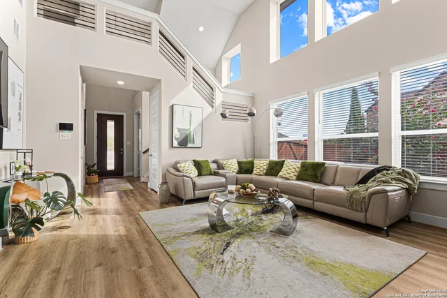 a living room with furniture window and a wooden floor