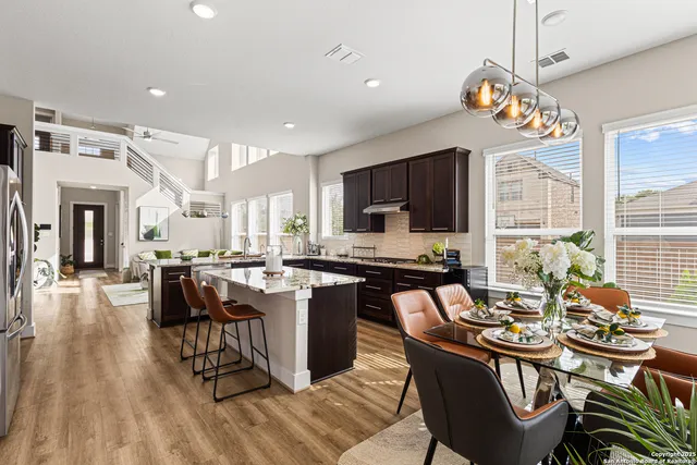 a view of a dining room with furniture a chandelier and wooden floor
